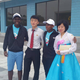 Students from North Korea and Tanzania pose with each other outside the camp’s headquarters.